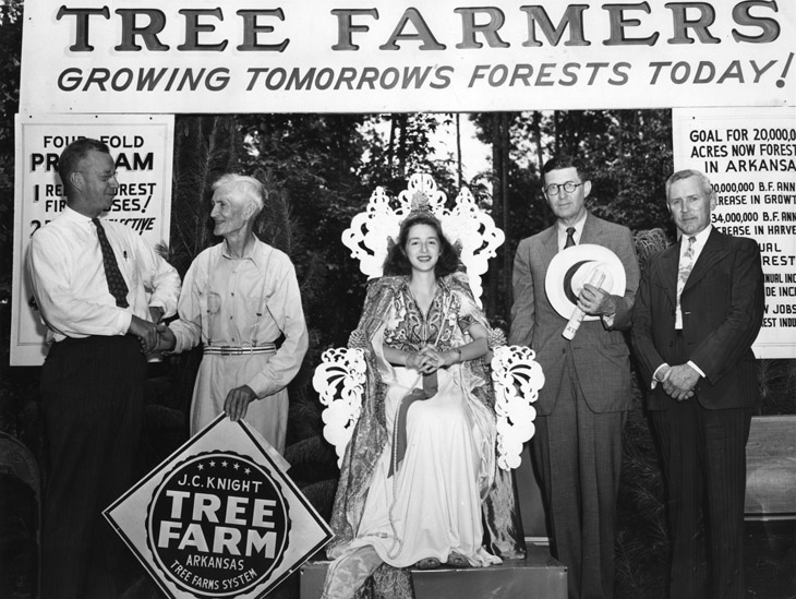 1942 Arkansas tree farm program dedication ceremony in Fordyce. John C. Knight, the state's first certified tree farmer, with sign.