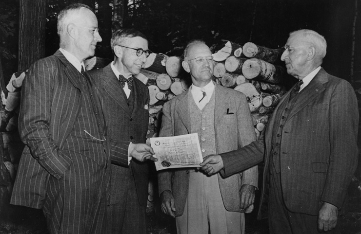 Robert H. Lawton (right) is awarded the first Tree Farm certificate in Massachusetts by Arthur T. Lyman, William B. Greeley, and R.B. Parmenter.