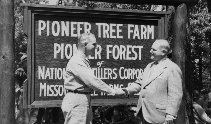 Missouri extension forester L.E. McCormick (left) congratulates Frank C. Kenyon (right), of National Distillers Products Corp., at 1949 dedication.