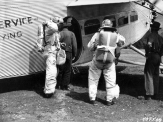 Two jumpers about to take off in Ford Trimotor plane, Lolo National Forest, Montana.
