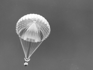 Smokejumpers with wind-filled chutes, Lolo National Forest, Montana.