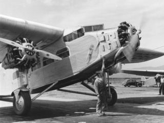 Ford Trimotor plane under contract from Johnson Flying Service about to take off with a squad of smokejumpers.