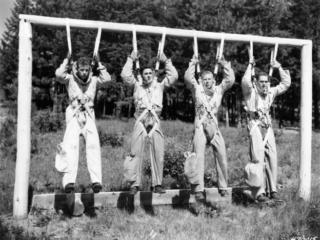 Smokejumper squadleader Bill Carver and new trainees fully suited practicing