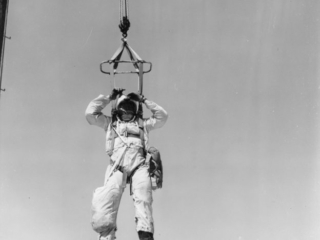 Forest Service smokejumper practicing let down techniques on training units at Aerial Fire Depot