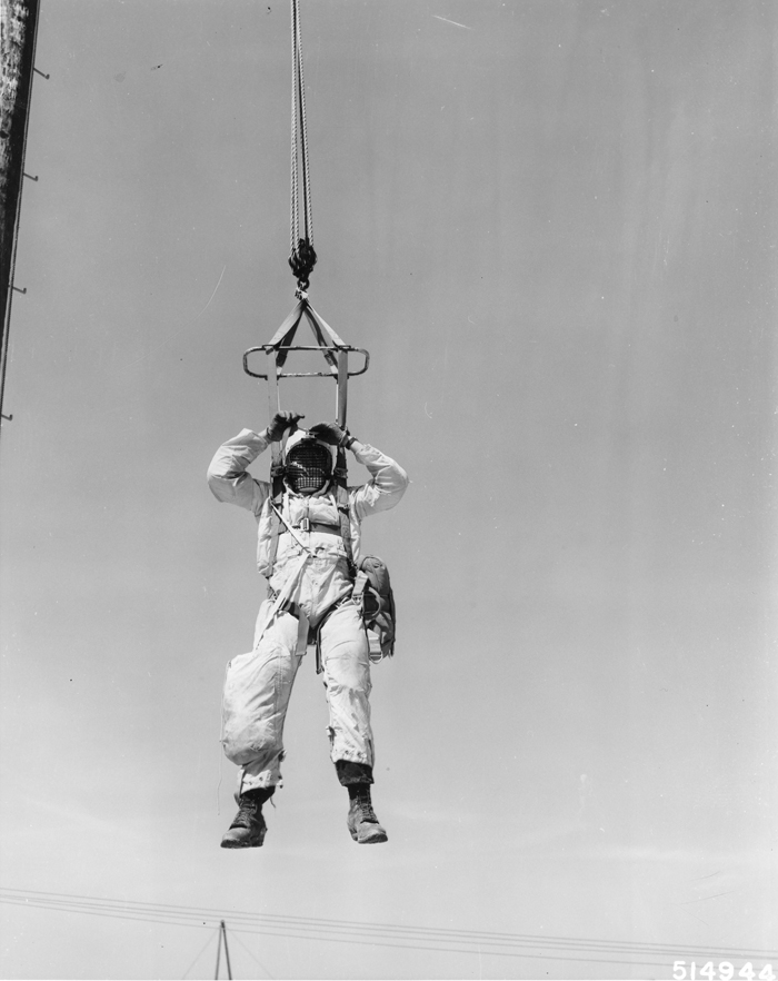 Forest Service smokejumper practicing let down techniques on training units at Aerial Fire Depot