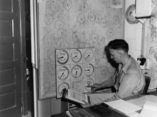Arranging fire-danger chart for the districts on the Shasta National Forest, 1953.